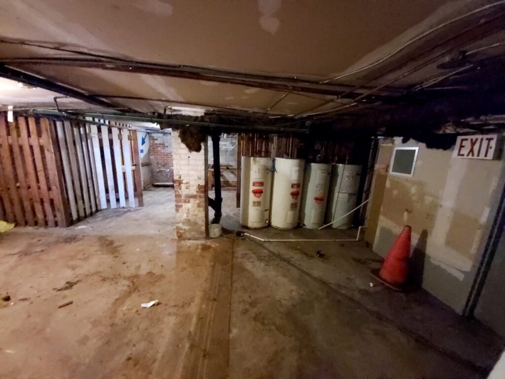 basement of heritage building showing old hot water heater tanks